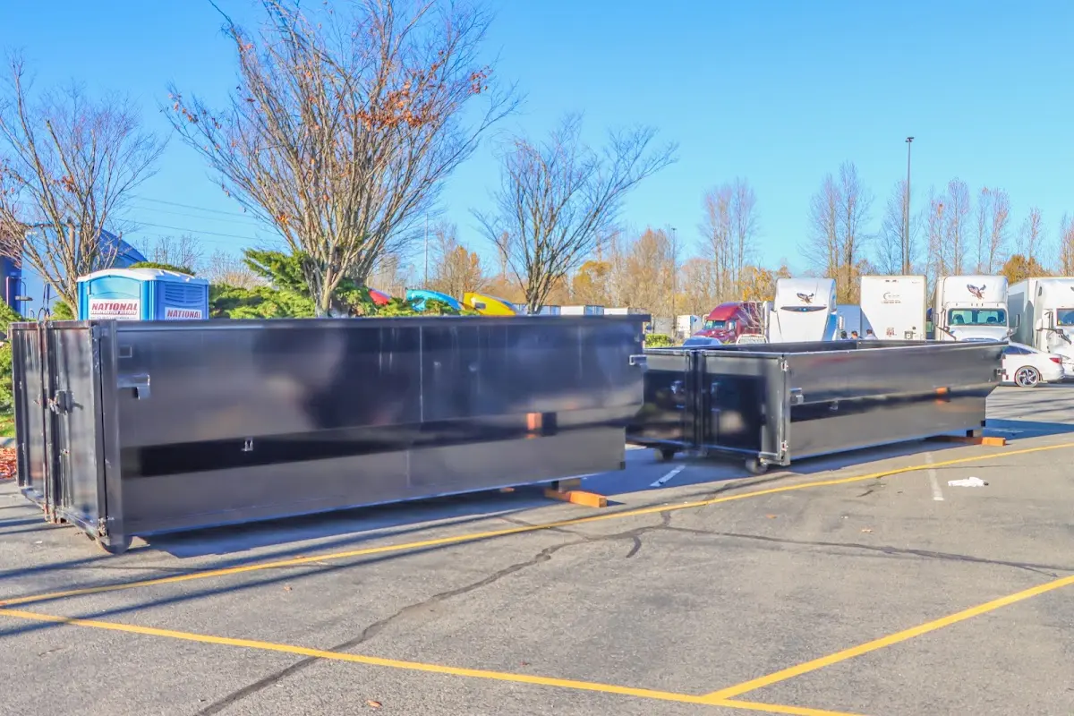 Professional dumpster rental service with roll-off container on residential driveway in North Aurora